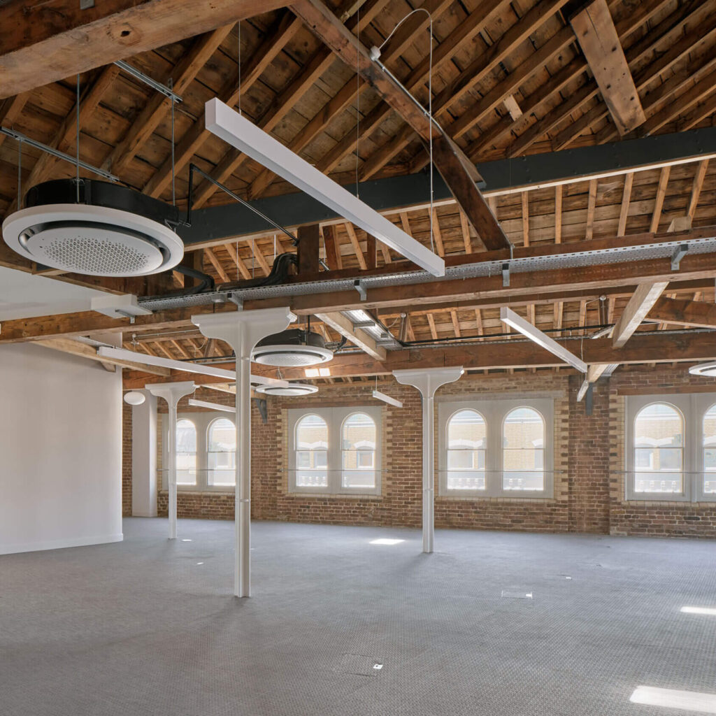 open-plan-office-exposed-timber-roof-arched-windows-menier-venues
