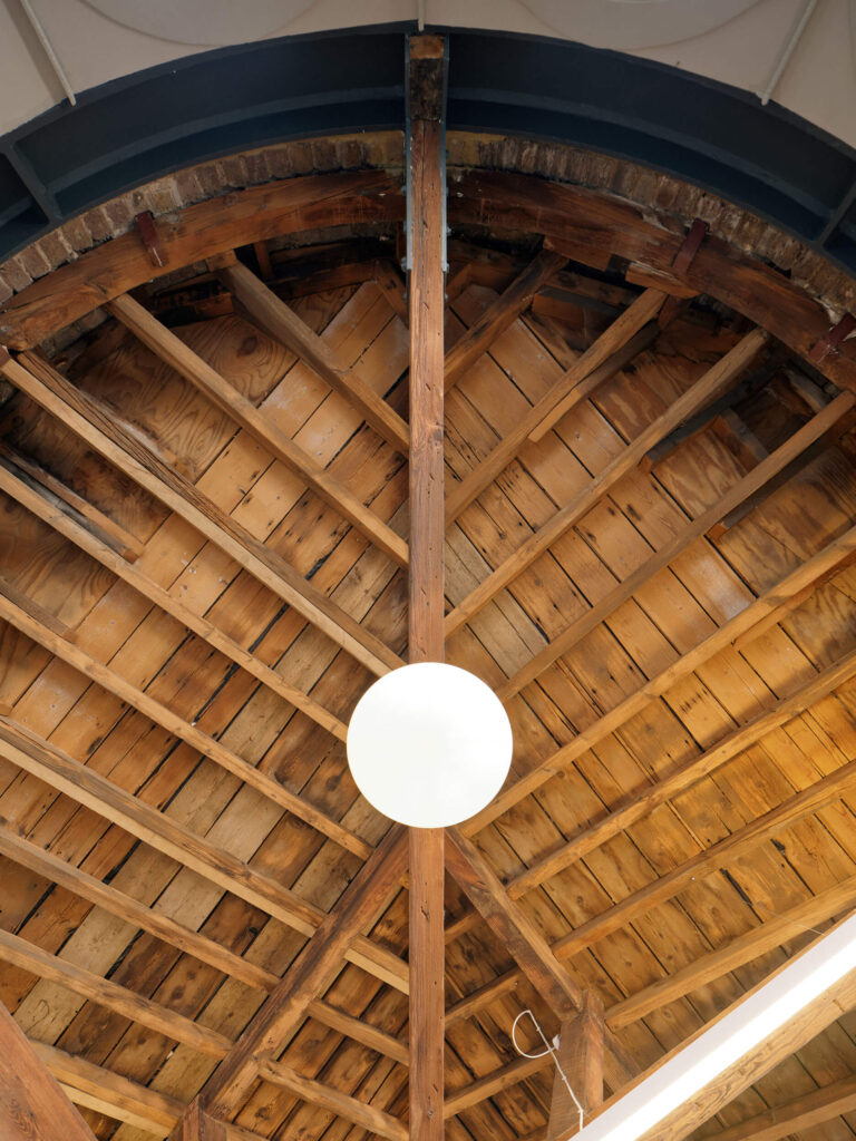 Rustic wooden ceiling with exposed beams and light