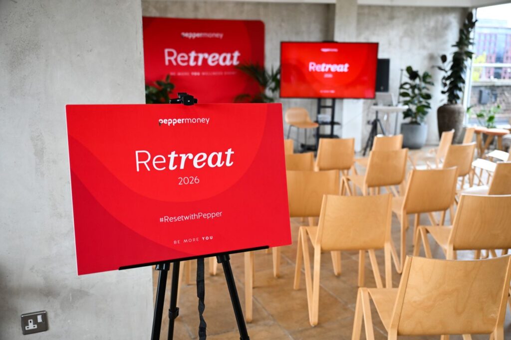 Red Pepper Money Retreat 2026 welcome sign displayed on an easel in front of theatre-style seating inside Menier Penthouse.